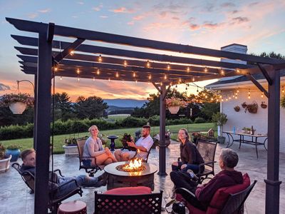 a-family-relaxing-around-a-fire-table-in-outdoor-s-2022-11-14-04-06-09-utc.jpg