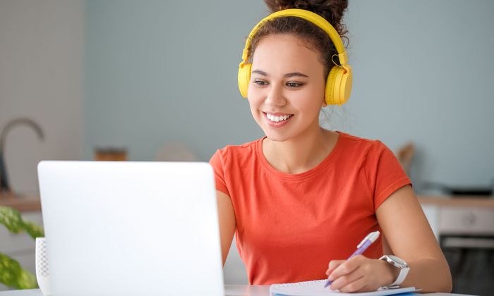 teen girl working on a laptop