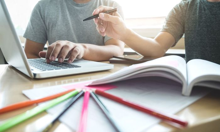 young people with notebooks and a laptop