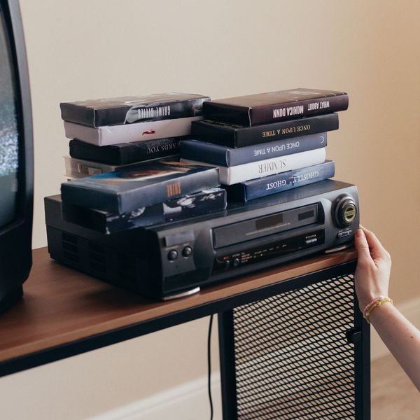 collection of VHS tapes on top of VCR collection of VHS tapes on top of VCR