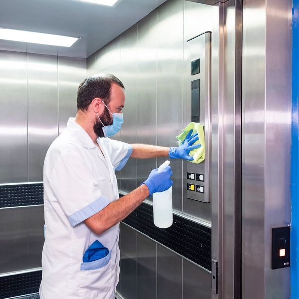 professional cleaner cleaning elevator