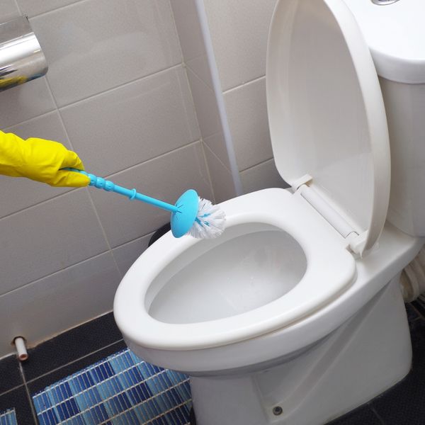 cleaning toilet in restroom