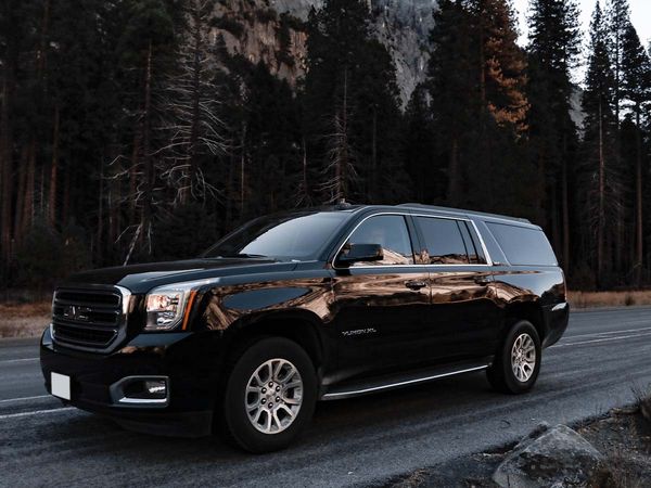 SUV limo driving down road