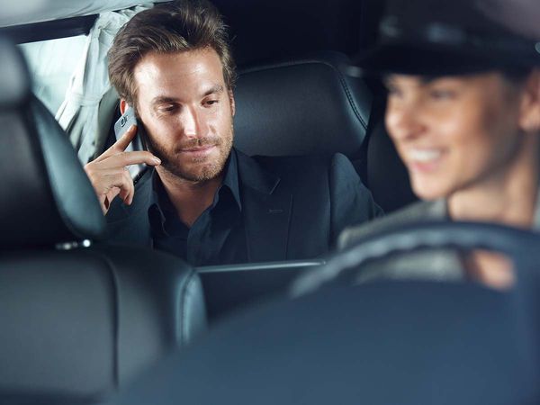 guy on phone while driving in a limo