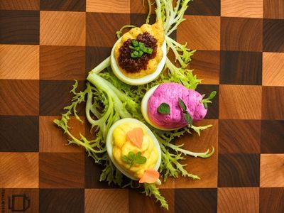 elevated deviled eggs on green garnish