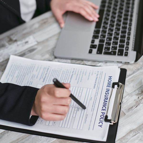 insurance agent filling out policy paperwork