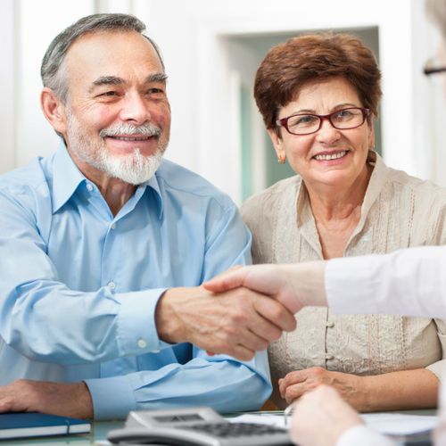 older couple shaking hands with insurance agent older couple shaking hands with insurance agent