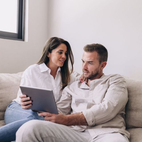 couple looking at tablet together couple looking at tablet together