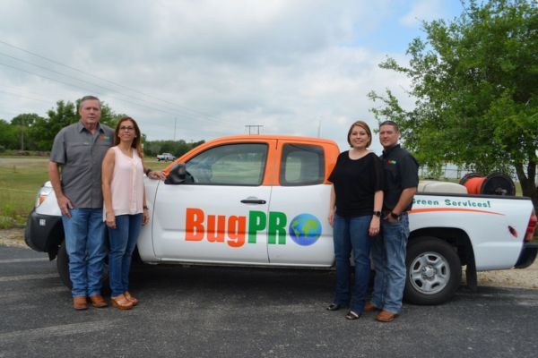 Owners of BugPro posting by a company truck About Us.jpg