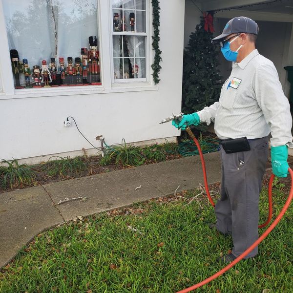 a man spraying a home with mosquito repellent Why a Professional Mosquito Control Plan.jpg
