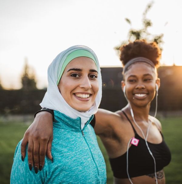 Two young woman smiling after a jog