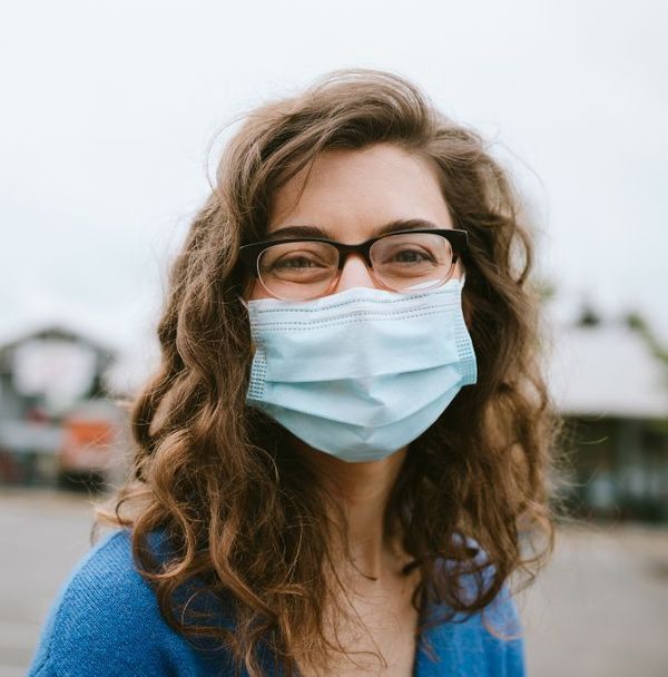 A portrait of a happy woman in a face mask