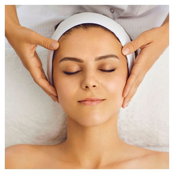 woman with hands on head, soothing medspa concept