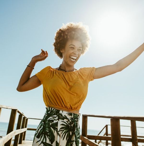 A happy woman outside on a dock