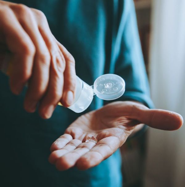 A person using hand sanitizer