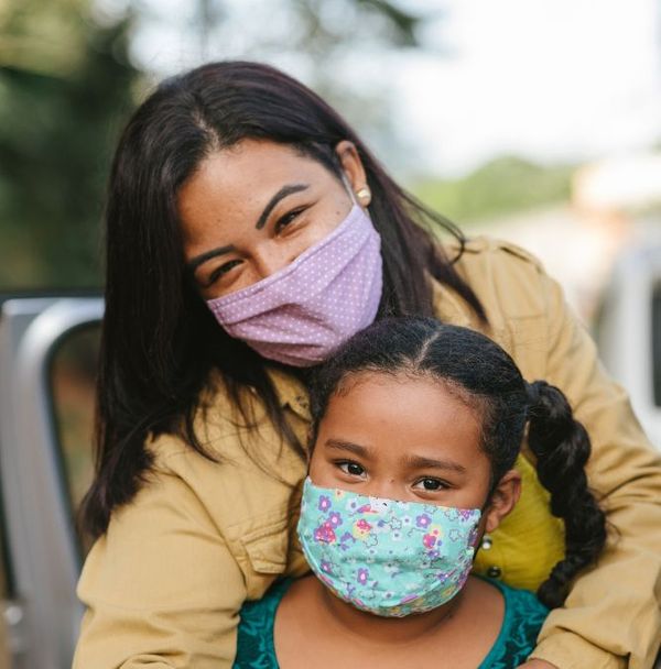 A mother and daughter wearing face masks