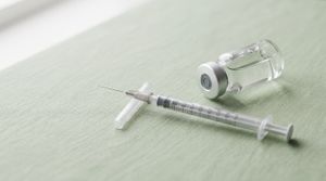 Glass vial and syringe representing the KLOW peptide blend, used in a wellness clinic explainer article