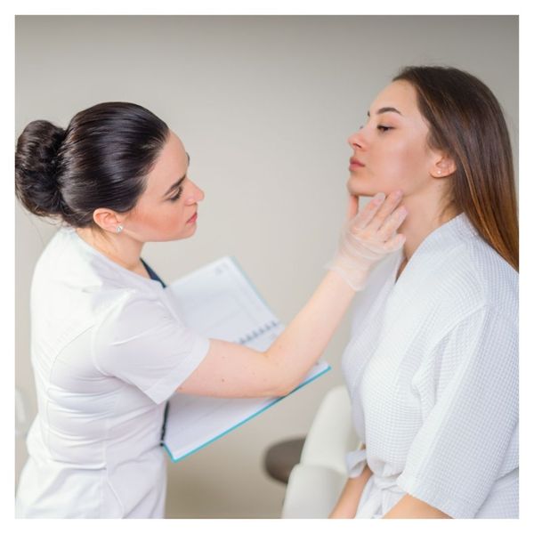 clinician looking at patient's cheek