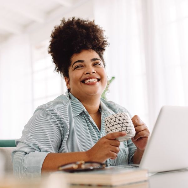 A smiling woman at her computer