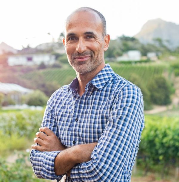 A middle aged man outdoors smiling