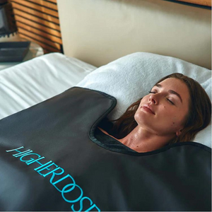 A woman practicing self care with infrared sauna blanket