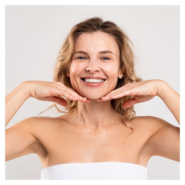 woman smiling, hands on chin