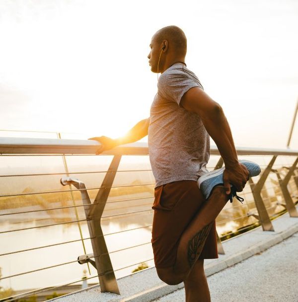 A man stretching his legs before a run