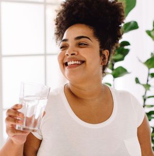 A happy woman with a glass of water