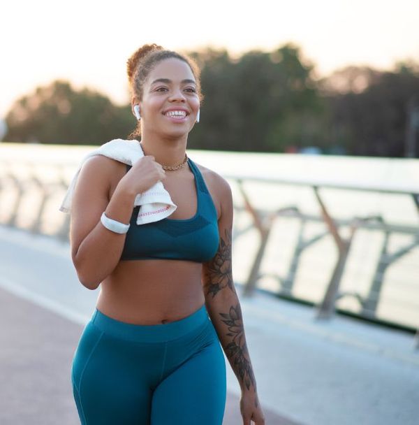 A woman walking outside after a run