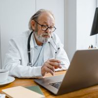 doctor talking to a patient using a computer