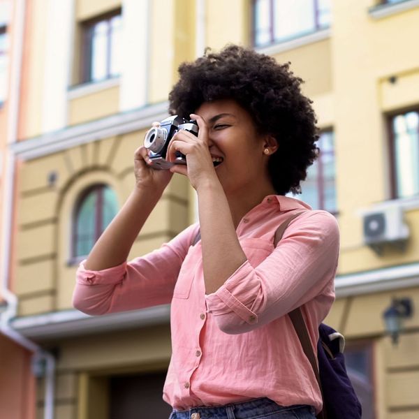 An image of a woman taking a photo.
