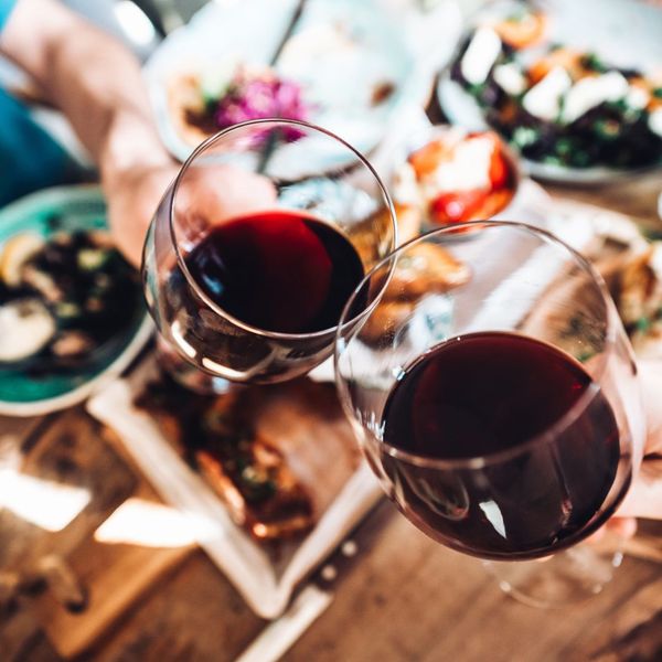 An image of people touching their wine glasses together.