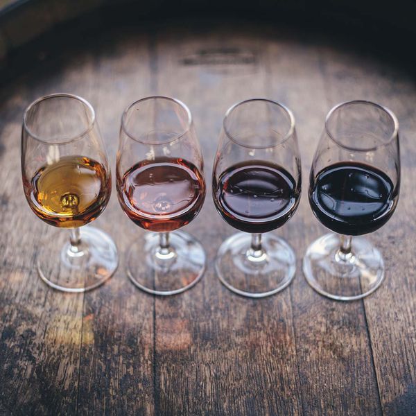 Image of 4 wine glasses with different kinds of wine.