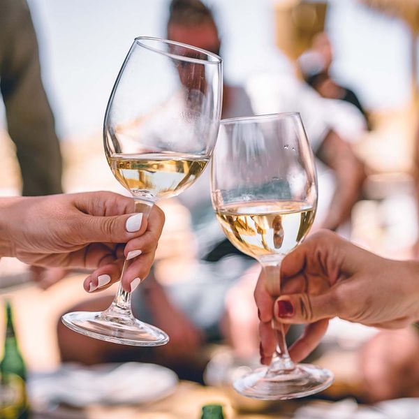 people holding two wine glasses