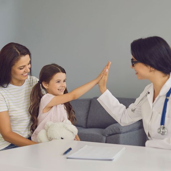 mom and daughter talking to a pediatrician