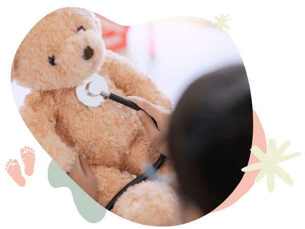 child playing doctor with teddy bear child playing doctor with teddy bear