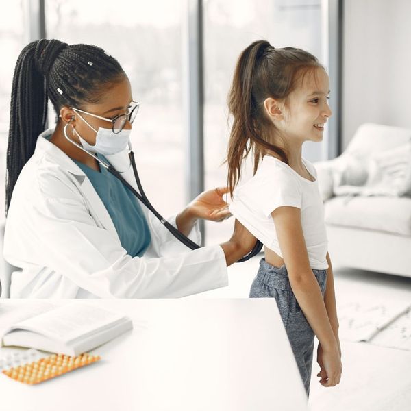 girl getting a wellness exam before back to school