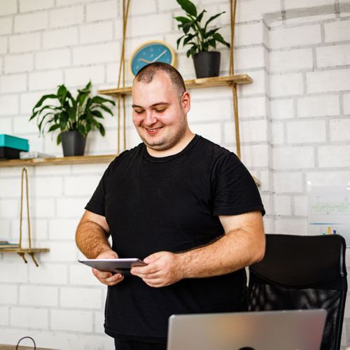 A content overweight man on his tablet