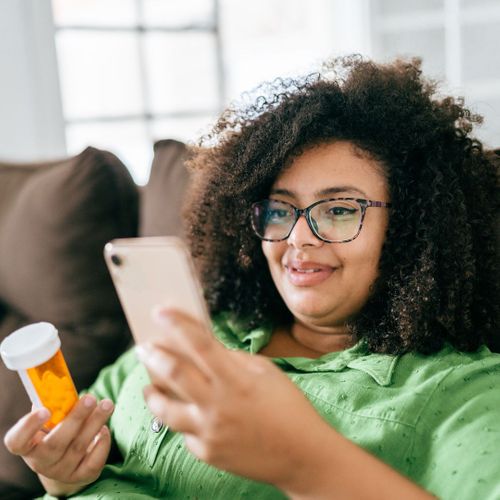 Woman on phone checking on medication