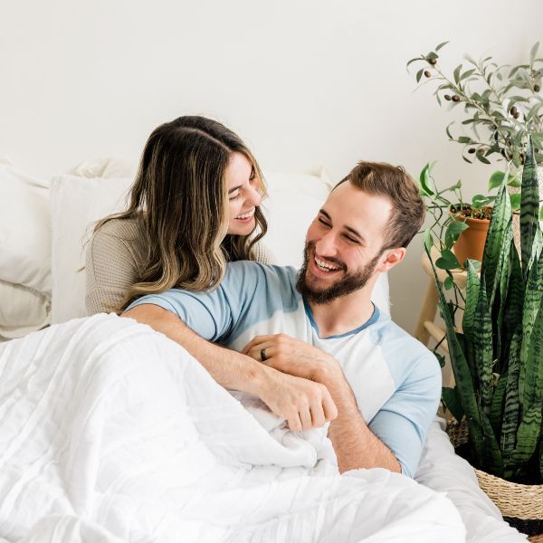 Couple relaxing in their bed