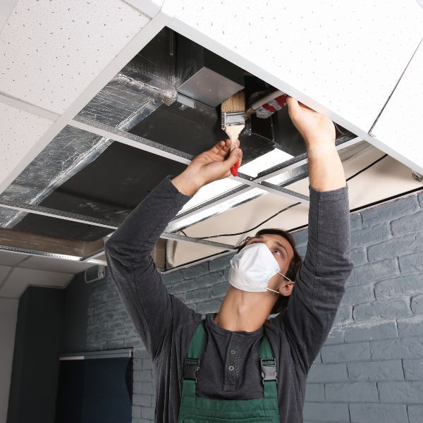HVAC tech cleaning a furnance