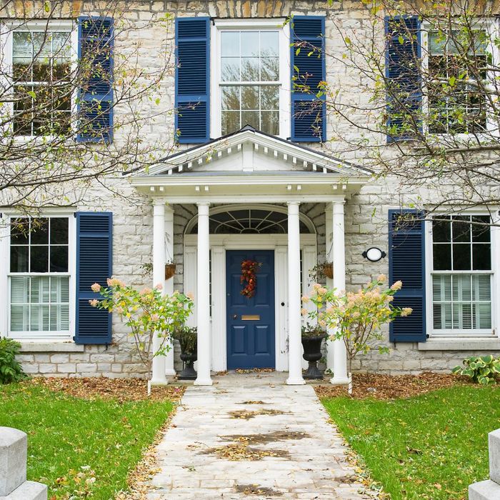 A beautiful home with bright blue shutters