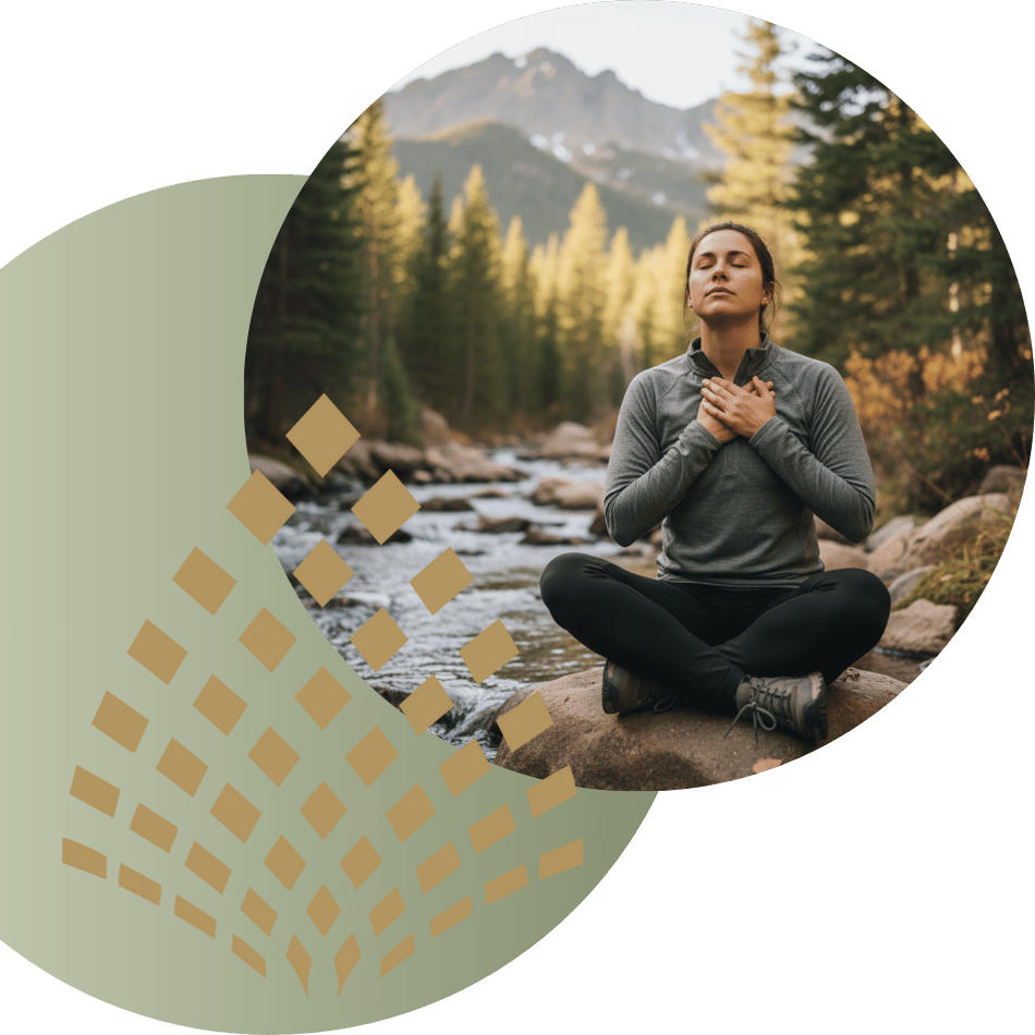 Person meditating or practicing mindfulness outdoors by a stream with mountains in the background, representing nature-based anxiety relief or therapy.
