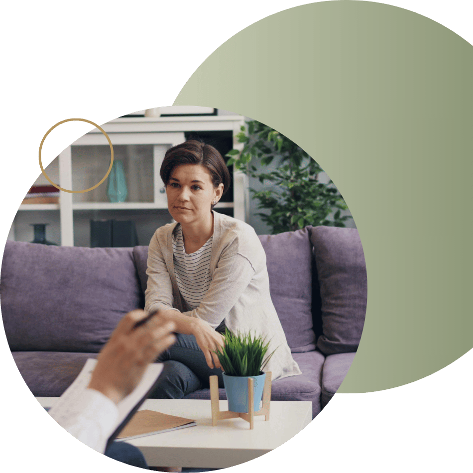 A woman sitting on a couch speaking to a therapist, representing individual counseling or depression therapy.