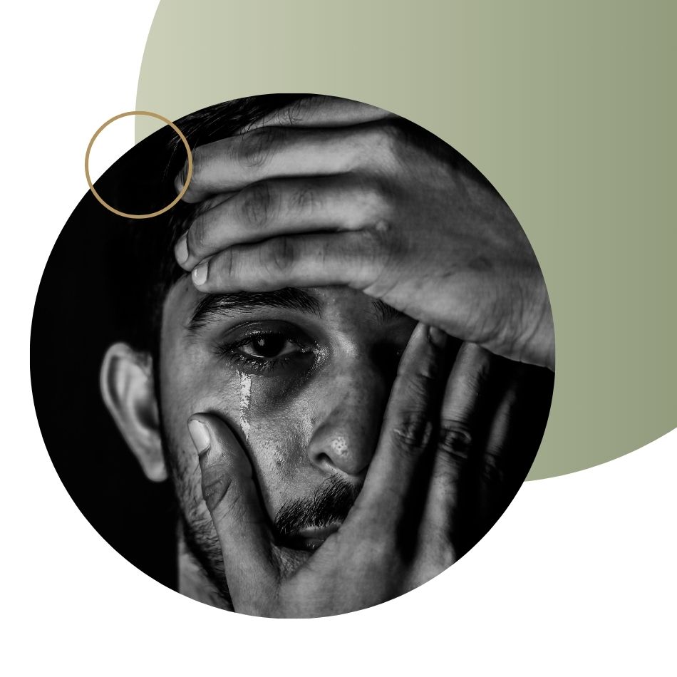 Man crying and holding his head