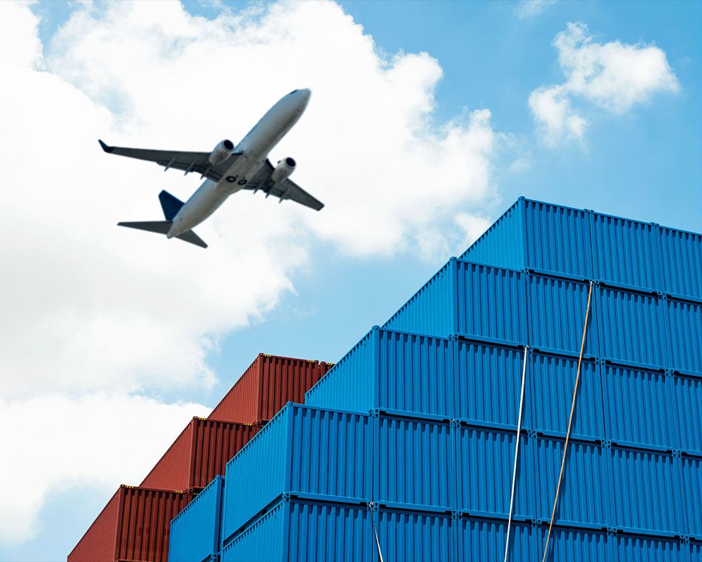 cargo containers with airplane in background