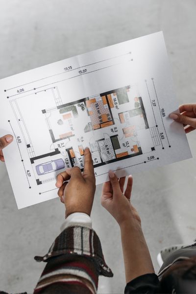 people review a floorplan drawing