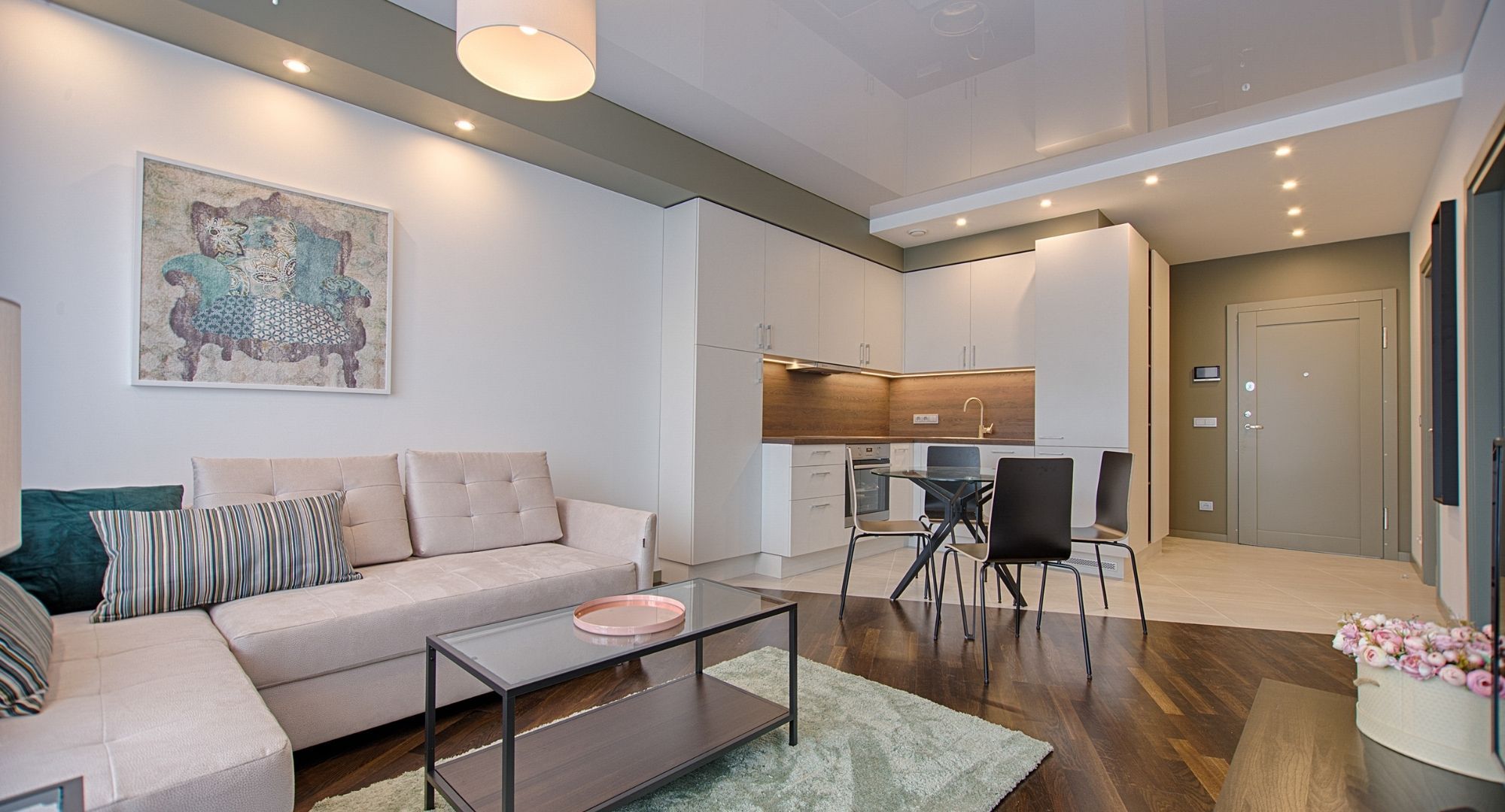 renovated apartment with white cabinets and wood floors