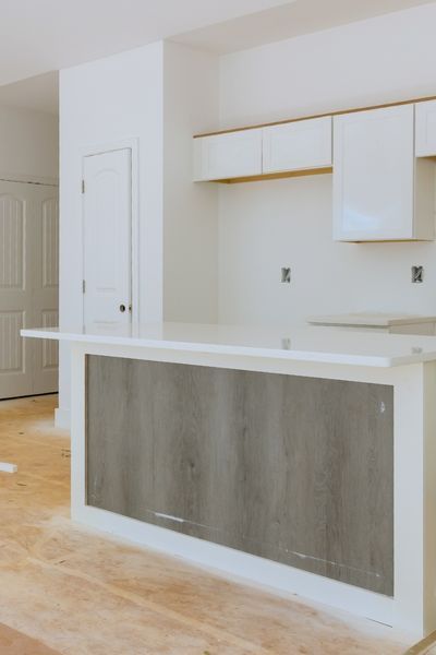 new white cabinets being installed for apartment kitchen renovation