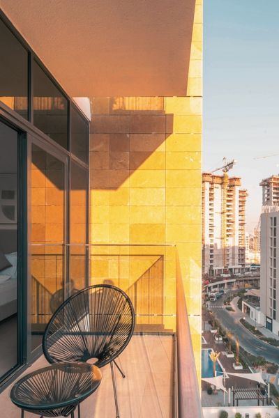 apartment balcony with modern chairs in sunlight 